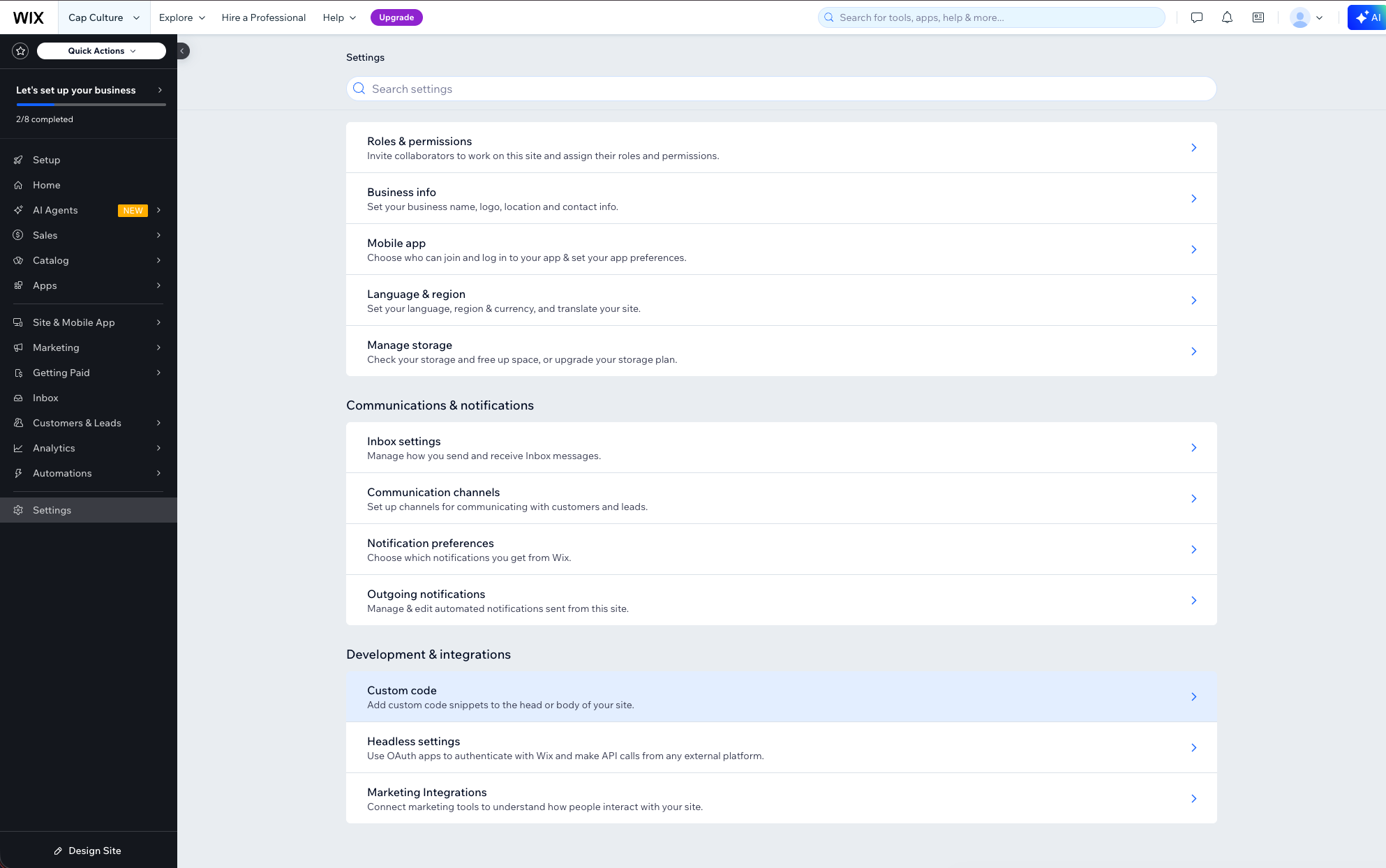 Wix Settings page showing the Development & integrations section with Custom Code option